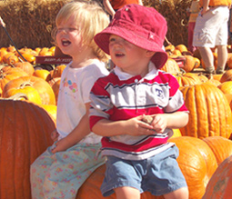 Isabelle helps Max in the pumpkin patch